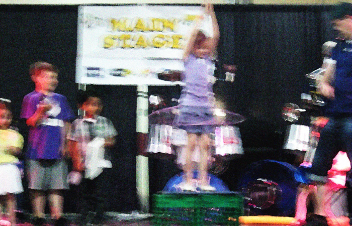 A girl learns to hoola-hoop.